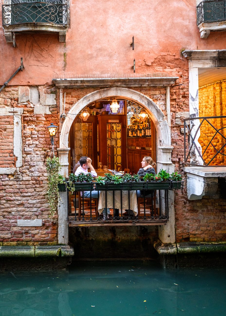 Romantic canal-side restaurant in Venice with a small balcony over the water