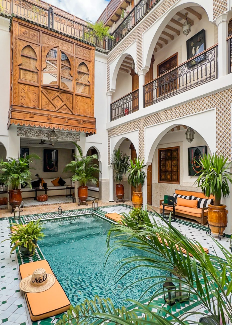 Peaceful riad courtyard in Marrakesh with tiled floors and greenery — where to stay in Marrakesh for first-timers.