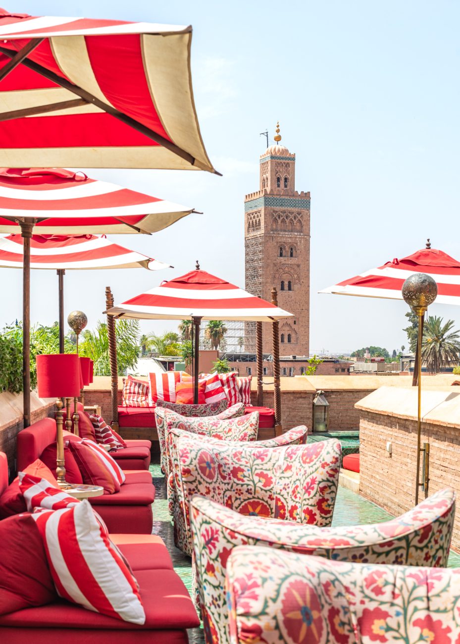 El Fenn rooftop terrace with seating, and Koutoubia Mosque in the distance
