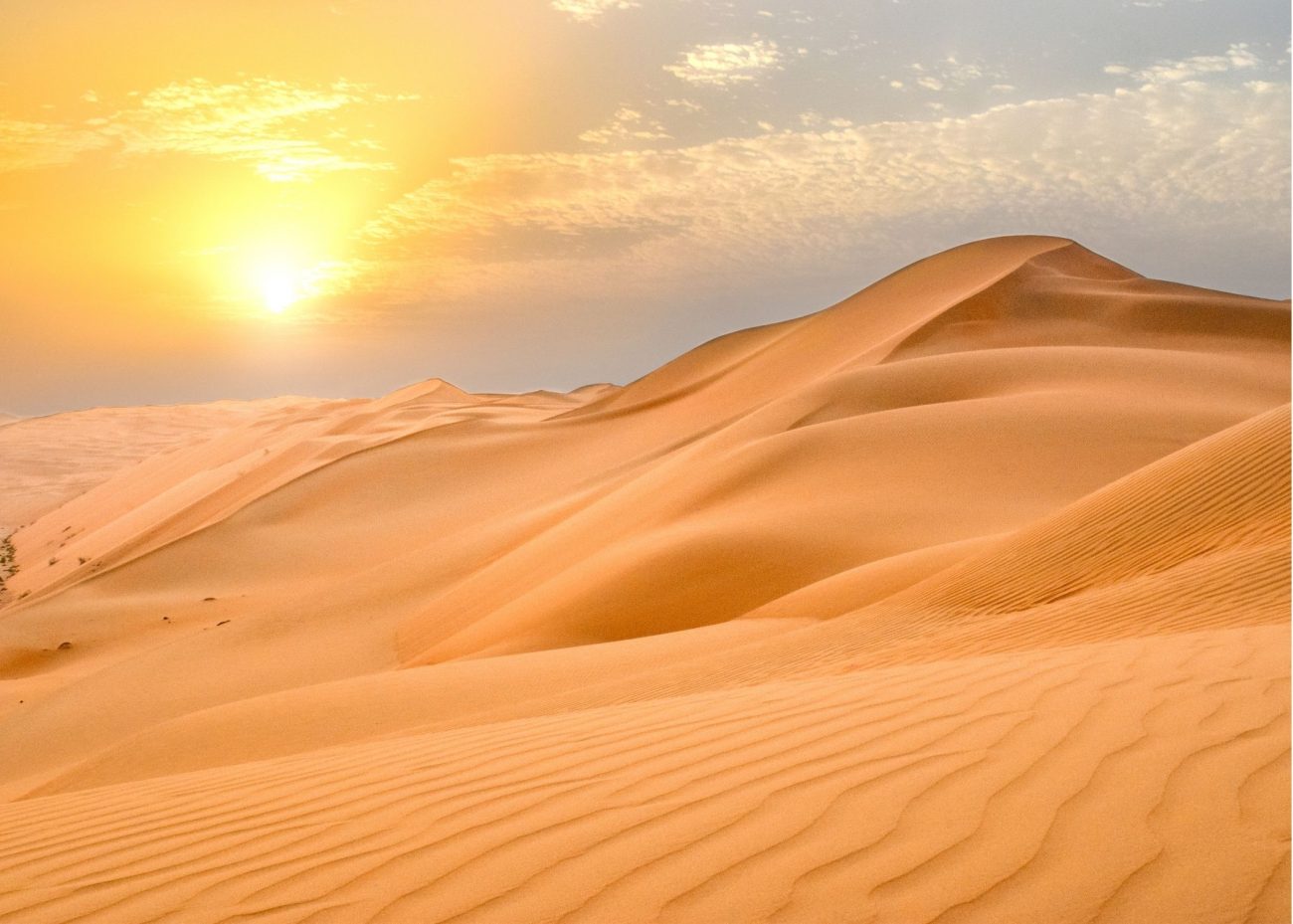 Sunset over the Agafay Desert near Marrakesh, with golden light on the rocky hills.