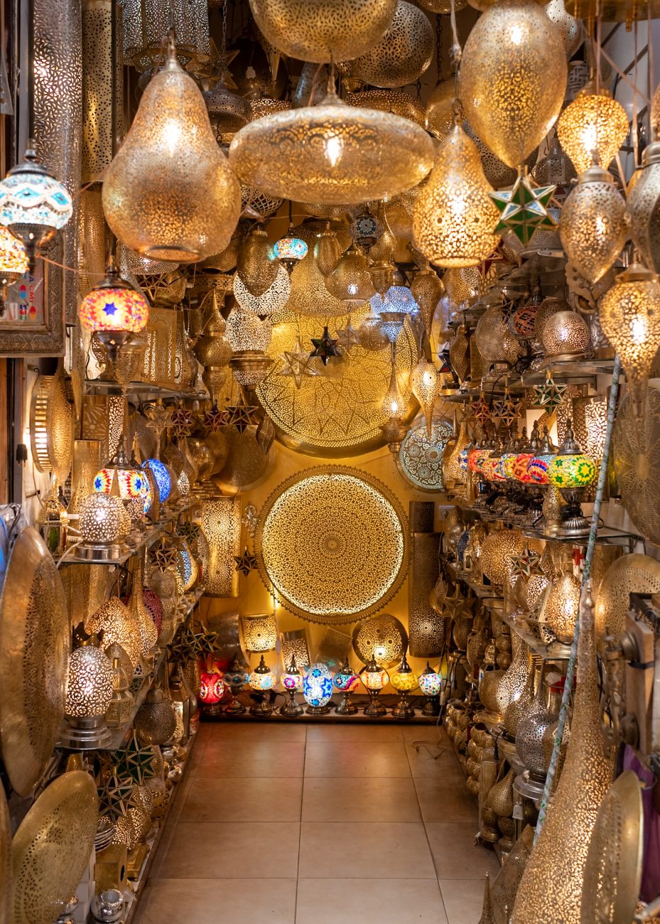 Market stalls in Marrakesh with a traveler negotiating prices — how to haggle in Marrakesh souks