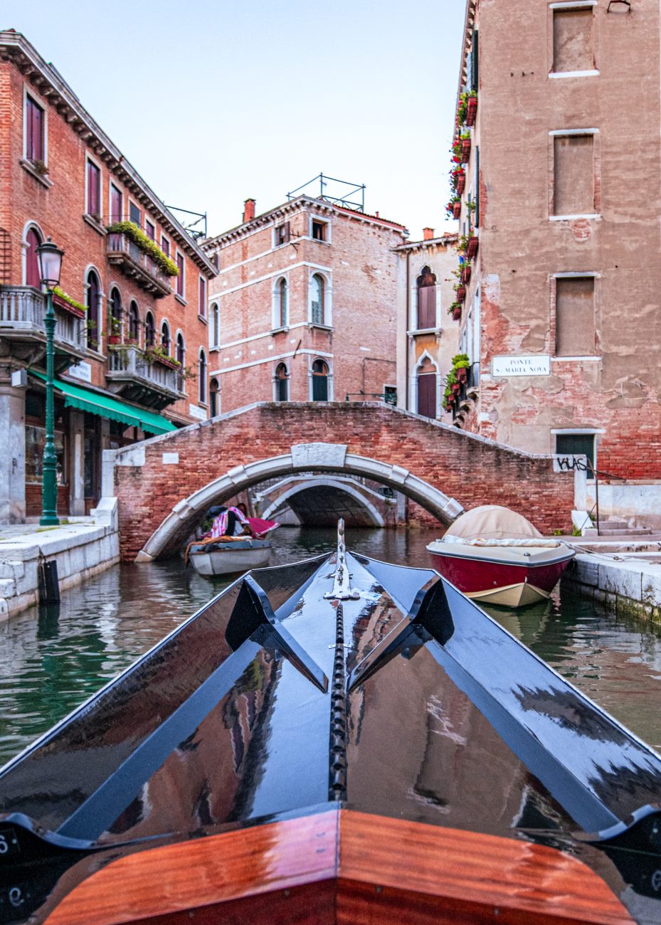 Private gondola in Venice with historic buildings along the canal