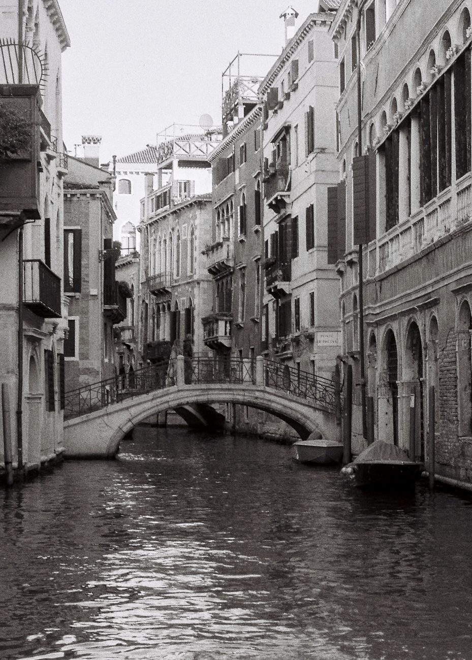 Small bridge over canal in Venice shot on black and white film