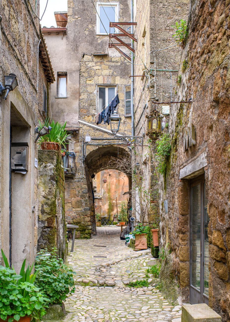 Narrow cobblestone street in Calcata Vecchia historic village near Rome Italy